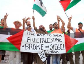Members of the latest Viva Palestina convoy celebrate after going through the Rafah crossing into Gaza